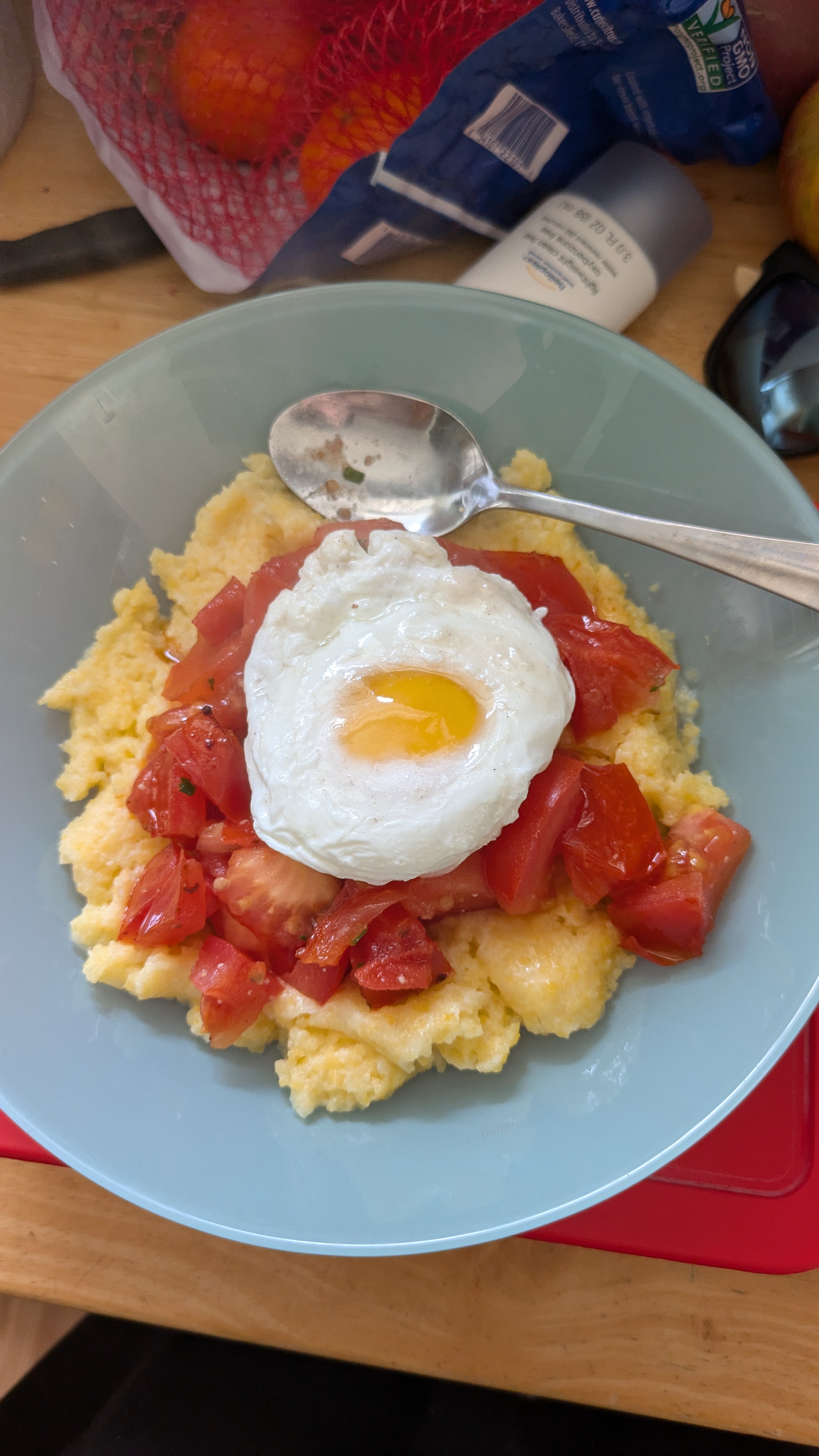 Eggs over easy with tomatoes and grits